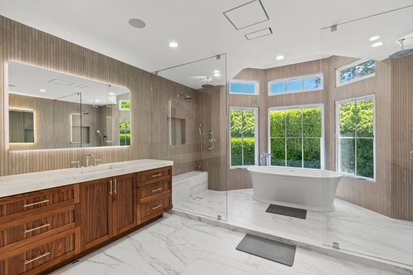 Diverse California buyers appreciating different bathroom features from tech to sustainability to luxury